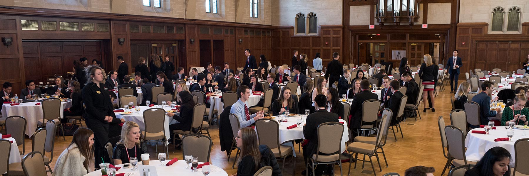 Groups of Kelley School of Business sophomore students sit around tables in Alumni Hall during the Sophomore Professional Week event.